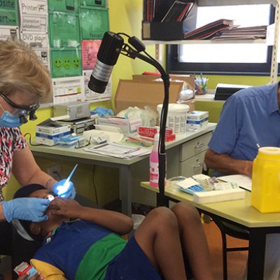 A young boy receives preventative oral dental treatments